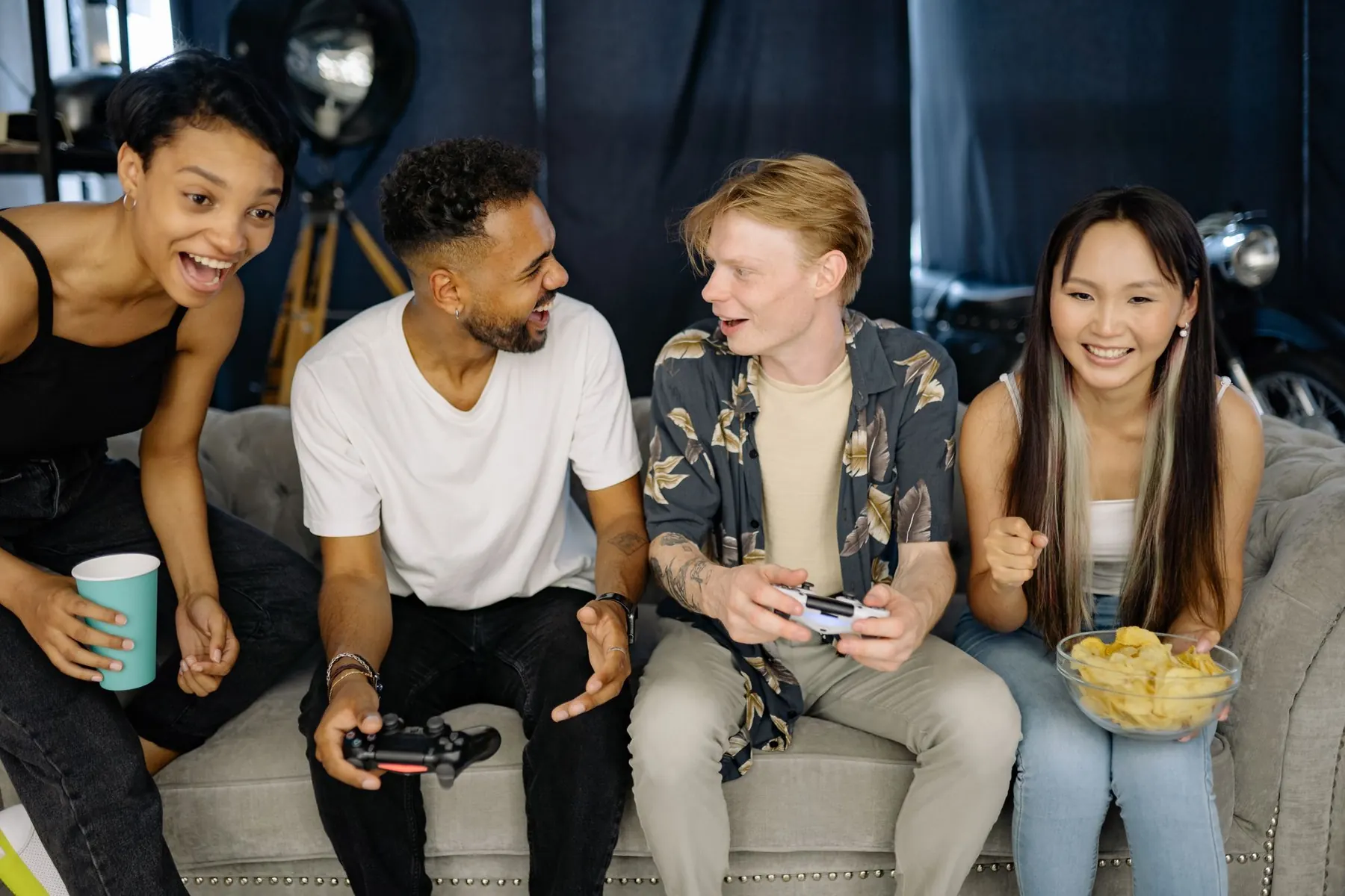 Friends laughing on a couch during a game night