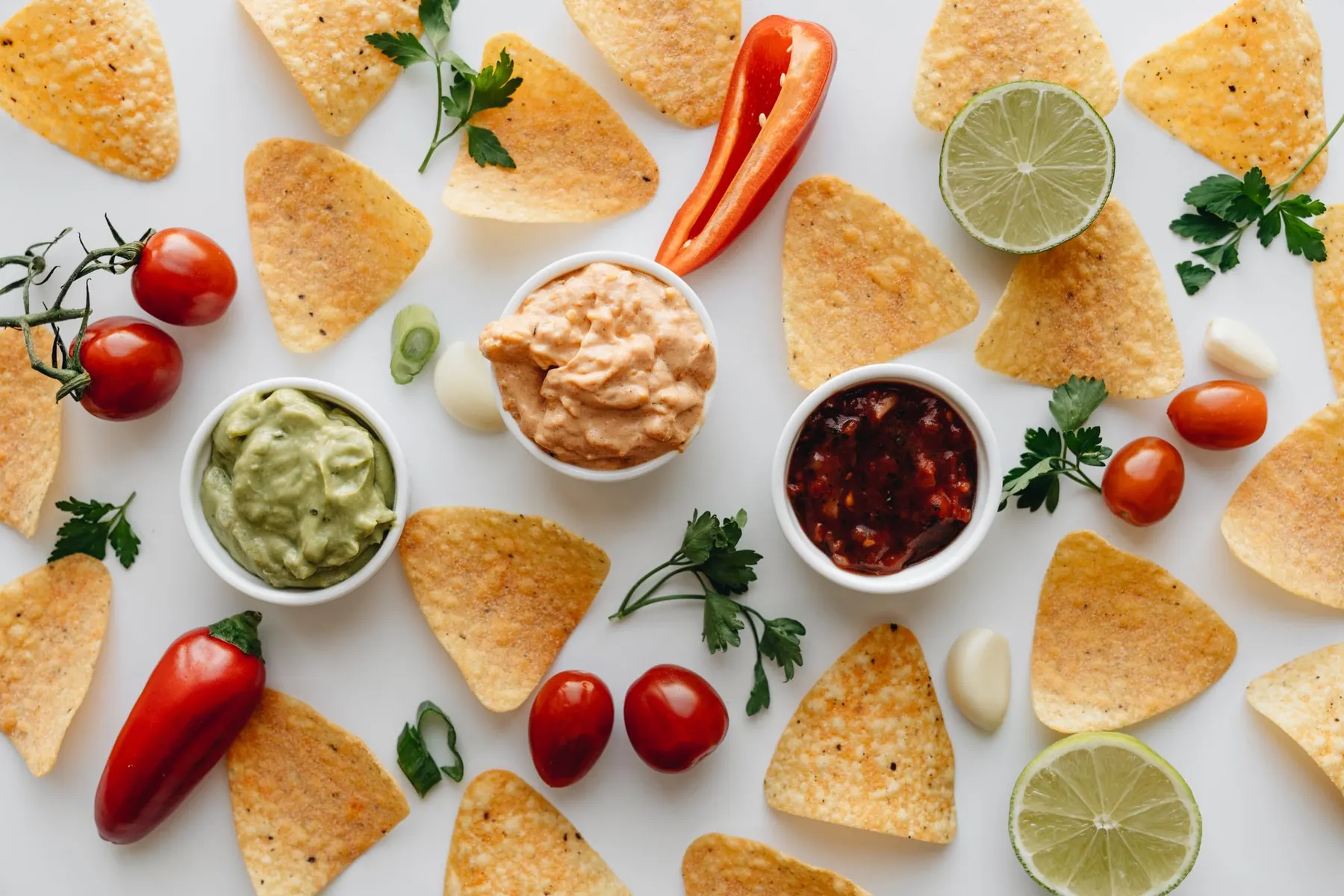 Corn chips with salsa and guacamole on a table